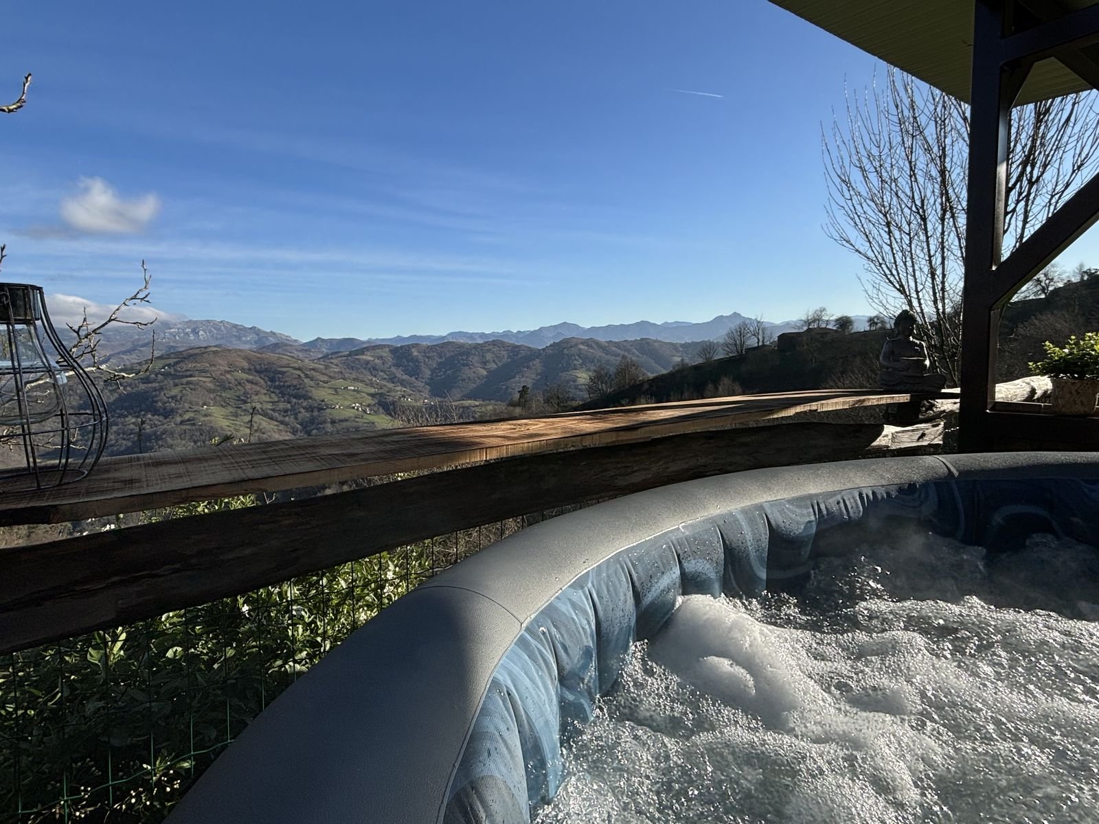 Bubbling hot tub with the Asturian mountains behind