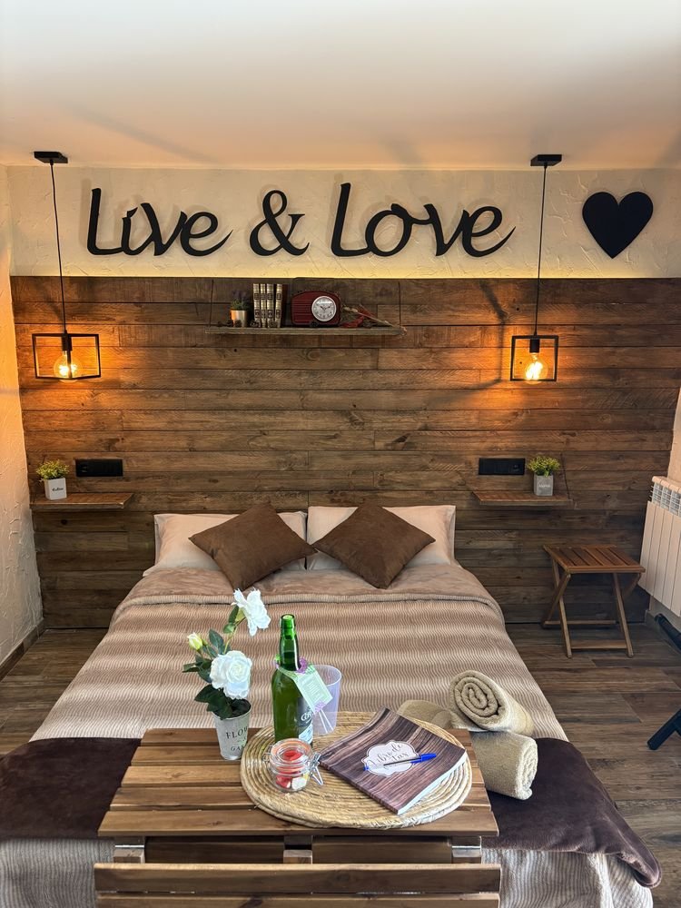 Bed with welcome touches beneath the Live and Love sign