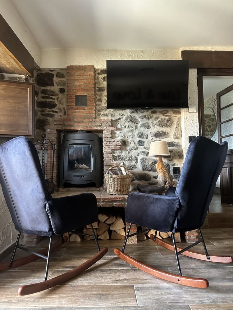 Rocking chairs by the wood-burning fireplace