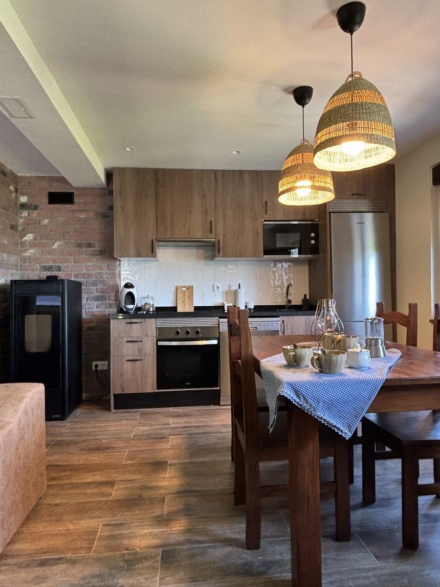 Kitchen and dining area with a wooden table