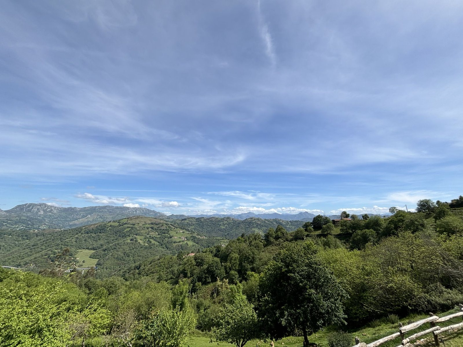 Valleys and hills of Siero with the mountain range behind, seen from the farm
