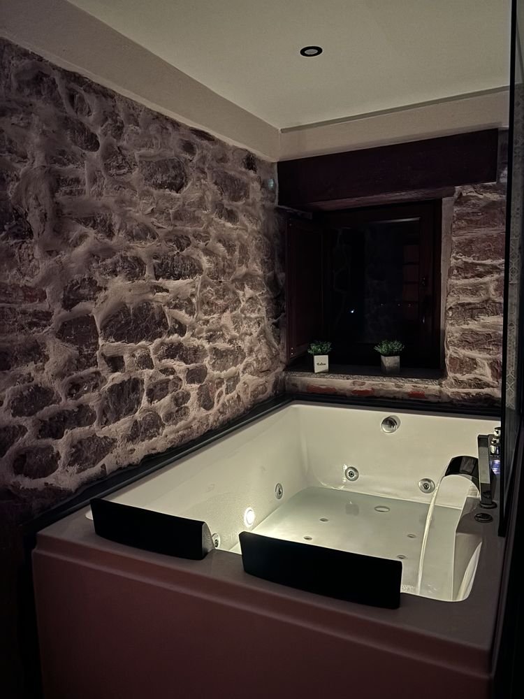 The whirlpool bath running beneath the stone window