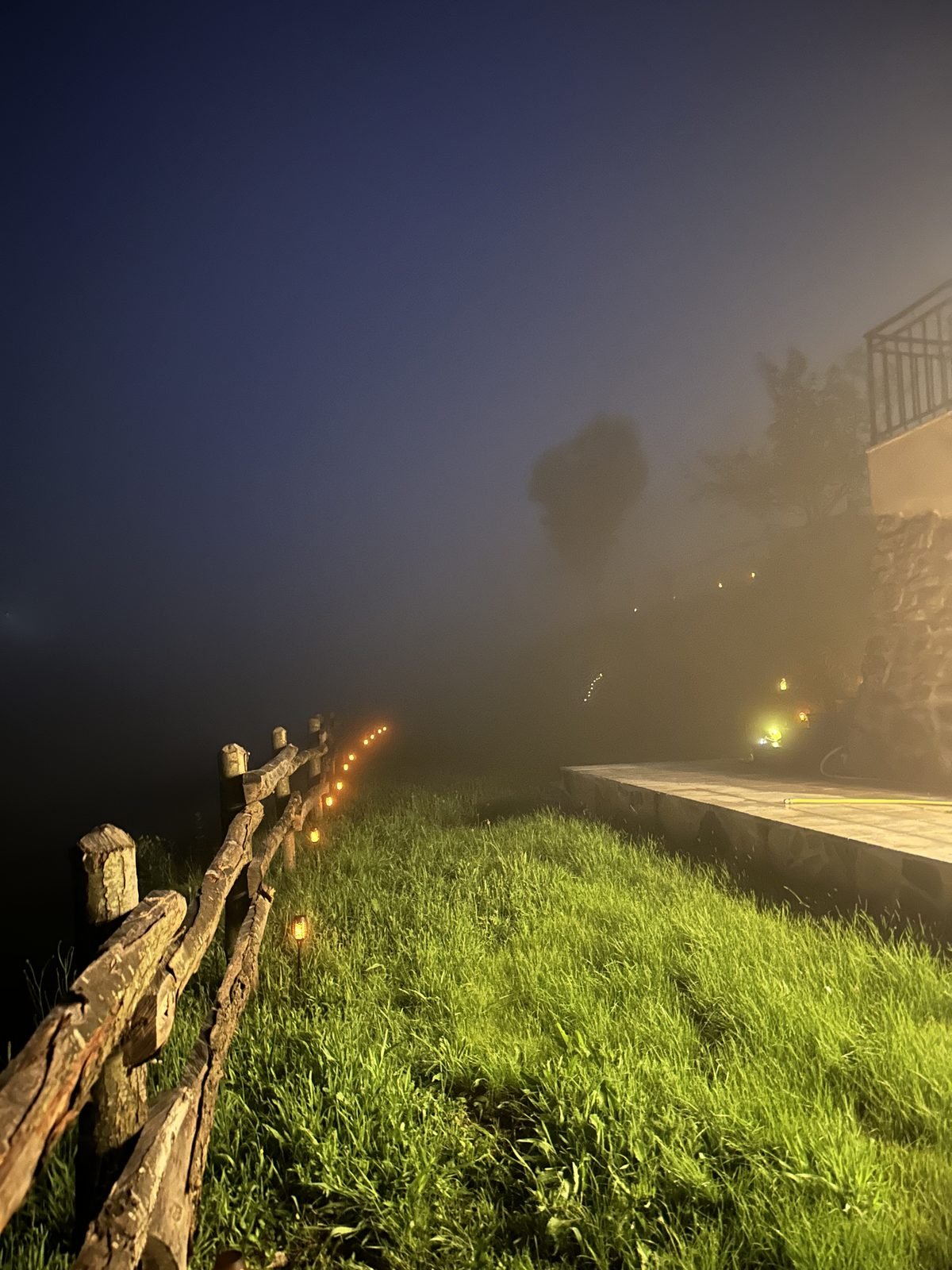 The wooden fence on a foggy night