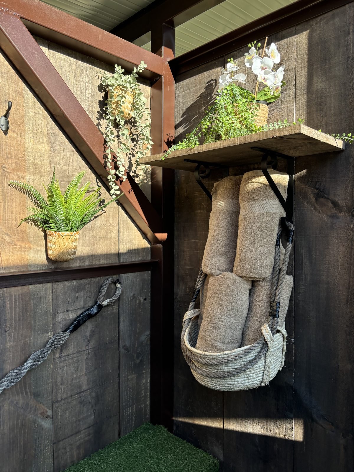 Rolled towels and plants in the hot tub cabin