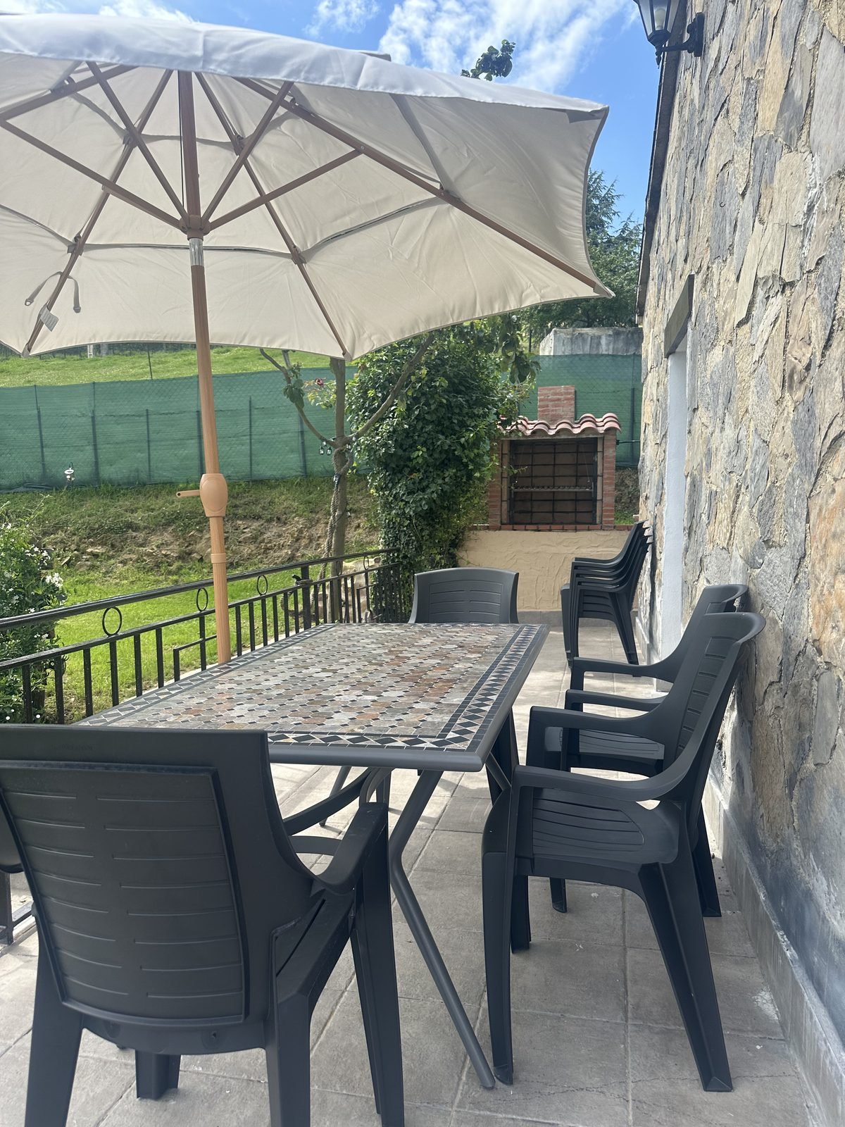 Mosaic table and chairs under the parasol